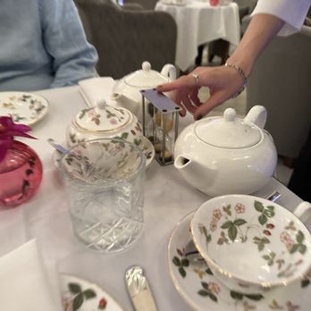 Afternoon Tea - a person setting a table in a restaurant - Tea Rooms Near Me - Montreal, Quebec