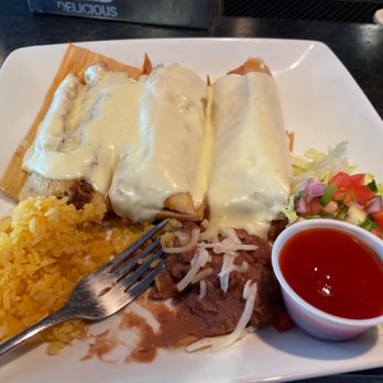 Daly's Bar and Grill - Three delicious pork tamales with house queso, rice and beans! - American Near Me - Sun Prairie, Wisconsin Daly's Bar and Grill - Three delicious pork tamales with house queso, rice and beans! - American Near Me - Sun Prairie, Wisconsin
