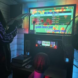 Shout Karaoke - The set-up includes 2 microphones, TV, and a large Korean remote (there is an English legend on the wall)