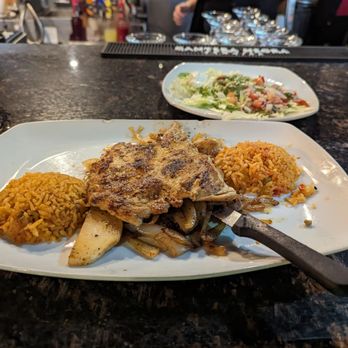 El Jalisco - Grilled chicken with onions. Rice on the side. Guacamole salad with Pico de Gallo included - about 16 dollars - Mexican Near Me - Tallahassee, Florida