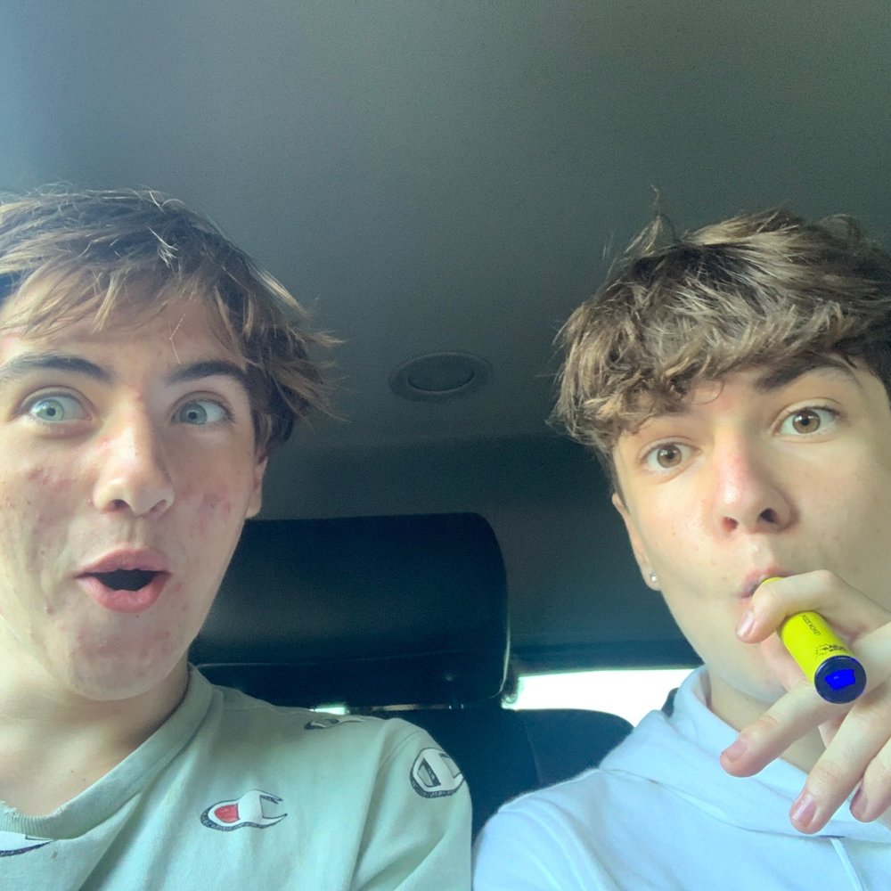 two men brushing their teeth two men brushing their teeth