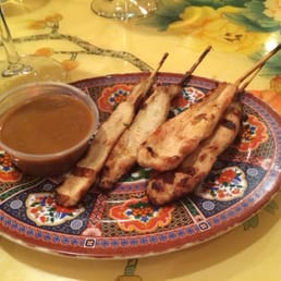 a plate of skewered meat and sauce a plate of skewered meat and sauce