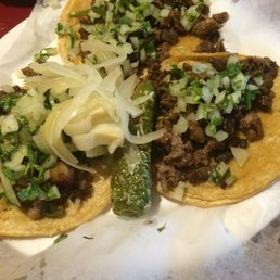 Three steak tacos - served with limes, grilled onions, and a roasted jalapeño. Delicious! Three steak tacos - served with limes, grilled onions, and a roasted jalapeño. Delicious!