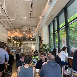 people sitting at tables in a restaurant