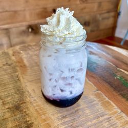 Solid Coffee - Blueberry Italian Soda. Made with blueberry syrup, seltzer, cream and home made vanilla whipped cream.