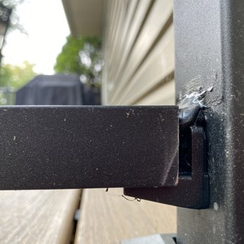 Elevated Contracting Solutions - Bottom railing cut too short with black caulking on top. - Roofing Near Me Elevated Contracting Solutions - Bottom railing cut too short with black caulking on top. - Roofing Near Me