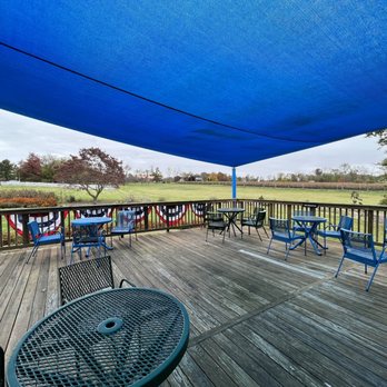 Hiddencroft Vineyards - a covered deck with tables and chairs - Wine Tasting Room Near Me - Lovettsville, Virginia Hiddencroft Vineyards - a covered deck with tables and chairs - Wine Tasting Room Near Me - Lovettsville, Virginia