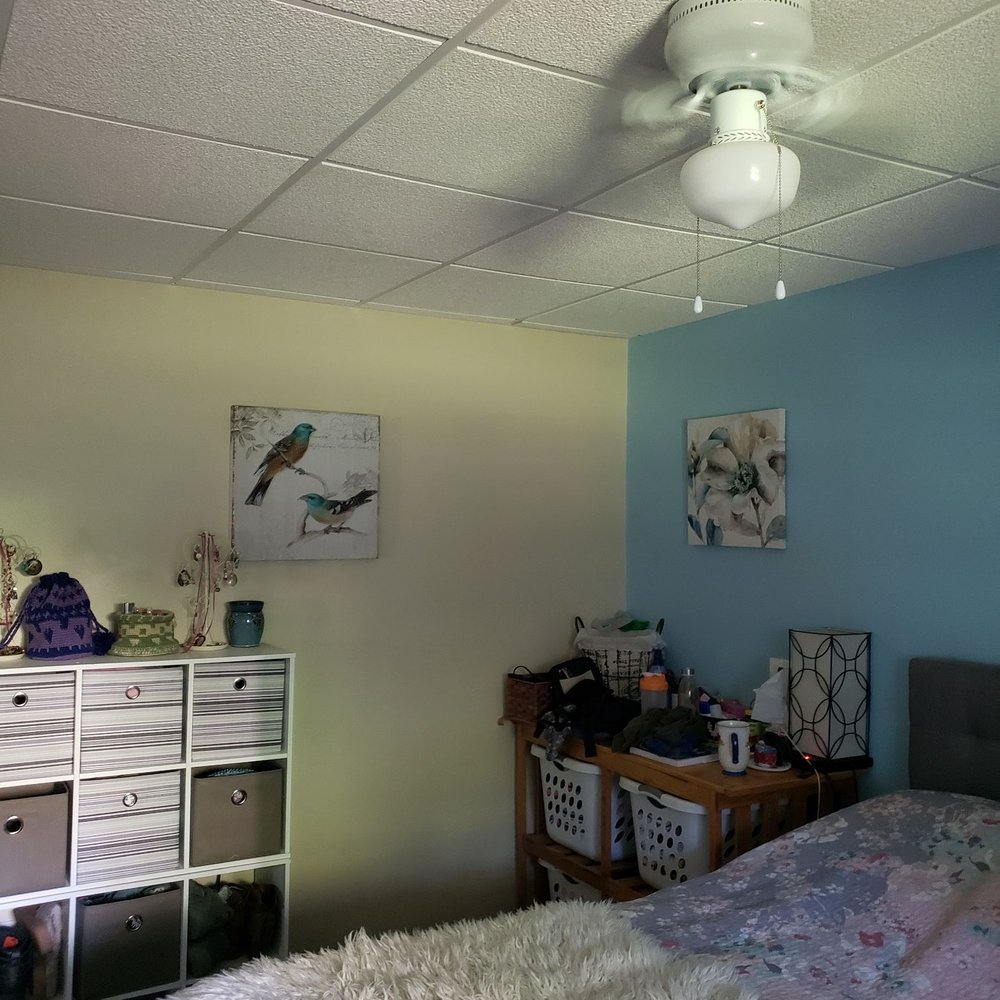 Torres Construction - a bedroom with a ceiling fan - General Contractors Near Me
