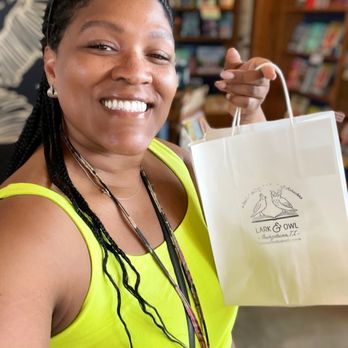 Lark & Owl Booksellers - a smiling woman holding a shopping bag - Bookstores Near Me - Georgetown, Texas Lark & Owl Booksellers - a smiling woman holding a shopping bag - Bookstores Near Me - Georgetown, Texas