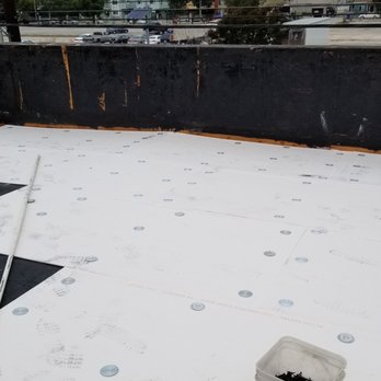 Maverick Roofing - 3/4" Densdeck being screwed down to roof deck. - Roofing Near Me - Compton, California Maverick Roofing - 3/4" Densdeck being screwed down to roof deck. - Roofing Near Me - Compton, California