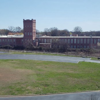 Lynx 36th Street Station - Old mill building from train approaching Station Northbound. - Public Transportation Near Me - Charlotte, North Carolina Lynx 36th Street Station - Old mill building from train approaching Station Northbound. - Public Transportation Near Me - Charlotte, North Carolina