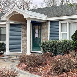 Home Exterior Experts - Stone accent and portico over the entryway finished off this Certainteed vinyl Siding installation nicely.