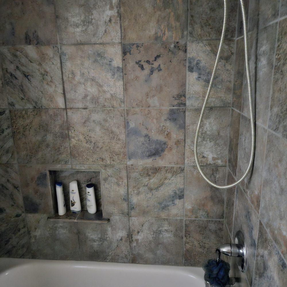 Diamond Design & Construction - a bathtub with a shower head - General Contractors Near Me - Lawton, Oklahoma Diamond Design & Construction - a bathtub with a shower head - General Contractors Near Me - Lawton, Oklahoma