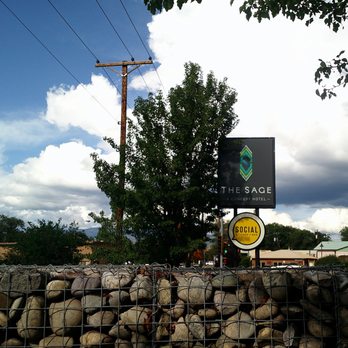 The Sage Hotel - Looking at the sign from inside the Social patio. Sangre de Christos mountain in the distance. - Hotels Near Me - Santa Fe, New Mexico The Sage Hotel - Looking at the sign from inside the Social patio. Sangre de Christos mountain in the distance. - Hotels Near Me - Santa Fe, New Mexico
