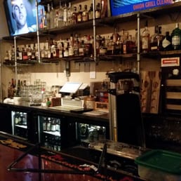 a bar with liquors on the shelves a bar with liquors on the shelves