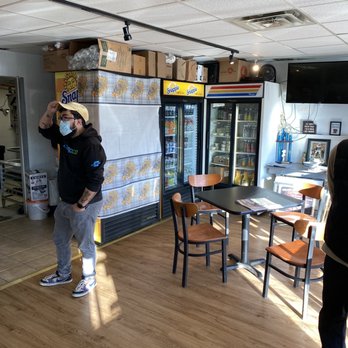 Uncle Leos & Rosny Gourmet - a man in a face mask standing in front of a refrigerator - Coffee & Tea Near Me - Wilton, Connecticut Uncle Leos & Rosny Gourmet - a man in a face mask standing in front of a refrigerator - Coffee & Tea Near Me - Wilton, Connecticut