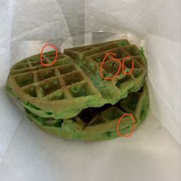 Residual burnt batter around the waffles.