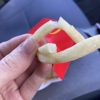 McDonald's - a hand holding a piece of french fries - Fast Food Near Me - Saratoga, California McDonald's - a hand holding a piece of french fries - Fast Food Near Me - Saratoga, California