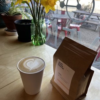 Cafe Velo - a cup of coffee and a bag of coffee - Coffee & Tea Near Me - Bellingham, Washington