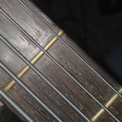 Hangar 18 - Glue smeared and dried around a reattached 2nd fret.