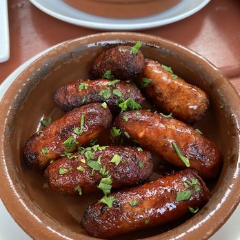 Tasca Restaurant - Txistorras de Cerdo Al Jerez -- pork sausage sautéed in cherry wine. We got the hot ones, they weren't spicy at all. - Spanish Near Me - Brighton, Massachusetts Tasca Restaurant - Txistorras de Cerdo Al Jerez -- pork sausage sautéed in cherry wine. We got the hot ones, they weren't spicy at all. - Spanish Near Me - Brighton, Massachusetts