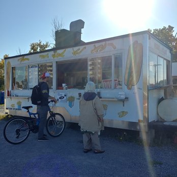 Claude Morin Chip Wagon - a man and a child standing in front of a food truck - Food Trucks Near Me
