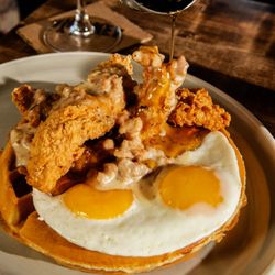 Whiskey Cake Kitchen And Bar - Chicken & Waffle:
malted waffle, crispy chicken tenders, sunny up eggs, maple syrup, country gravy