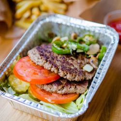 Five Guys - A photograph of the contents of a Five Guys burger bowl, which include two ground beef patties, tomatoes, jalapenos, lettuce ...