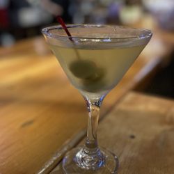 New England Steak & Seafood - Hot & Dirty Martini garnished with olives and jalapeño's