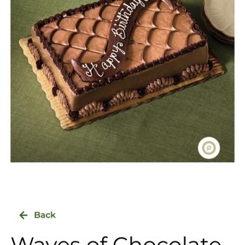 Publix - Expectations - A chocolate cake with a textured top design and a message written in white icing, placed on a green tablecloth. - Grocery Near Me - Saint Johns, Florida
