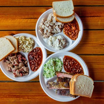 Phil's BBQ - three plates of food on a wooden table - Barbeque Near Me - Eufaula, Alabama Phil's BBQ - three plates of food on a wooden table - Barbeque Near Me - Eufaula, Alabama