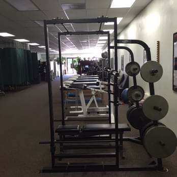 Dallmeyer Physical Therapy - Squat rack with Olympic bar, weights and adjustable bench for higher level strengthening - Physical Therapy Near Me - Santa Barbara, California