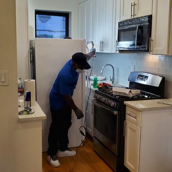 Dr. Buggz Pest Control - T and Michael pulling out fridge and vacuuming up roaches - Pest Control Near Me - Brooklyn, New York