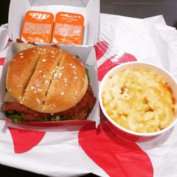 Spicy chicken sandwich with pepperjack on brioche, a side of Mac and cheese, and Buffalo sauce
