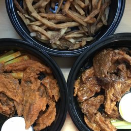 Delicious fresh cut fries; mouth watering & finger licking seitan wings (Buffalo on the left and Country Sweet on the right)
