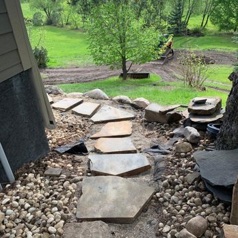 All Earth Construction - a stone path in a backyard - Landscaping Near Me