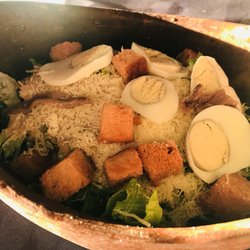 Banana's - Cesar salad is spectacular served in a stone bowl. Made the traditional way with anchovy dressing GET IT! :)..