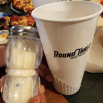 Round Table Pizza - a person holding a container of doughnuts - Pizza Near Me - Santa Ana, California Round Table Pizza - a person holding a container of doughnuts - Pizza Near Me - Santa Ana, California