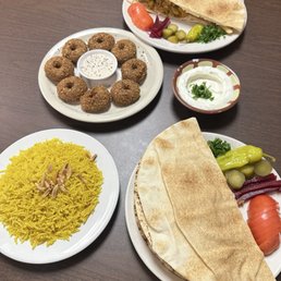 Chicken shawarma with rice,falafel, garlic sauce, and a chicken shawarma with fries
