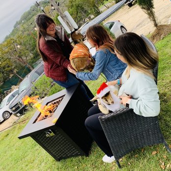 In Contrada Vineyard and Kitchen - Guests at the "Christmas Goats Cuddling" event enjoying the toasty mini firepits amid the fun goat cuddling :) ! - Wine Tasting Room Near Me - San Antonio, Texas