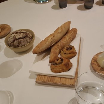Le Ciel - An assortment of freshly baked bread.  Chili butter on the left, regular butter on the right. - French Near Me - Vienna, 9