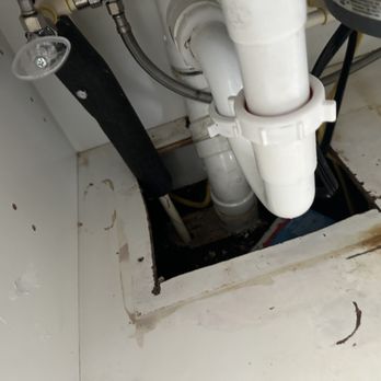 Home Shield Pest Solutions - This is a before photo of a large entry point underneath kitchen the kitchen cabinet - Pest Control Near Me