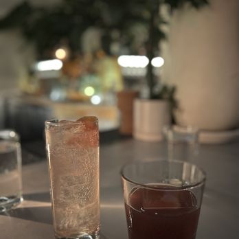 Public Records - a glass of water and a glass of ice on a table - Bars Near Me - Brooklyn, New York