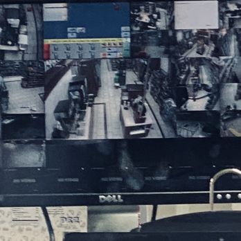 Chevron - The Security Camera view from outside, the clerk is sitting off to the right, tucked down under the cigarette display. - Gas Stations Near Me - Woodland Hills, California Chevron - The Security Camera view from outside, the clerk is sitting off to the right, tucked down under the cigarette display. - Gas Stations Near Me - Woodland Hills, California
