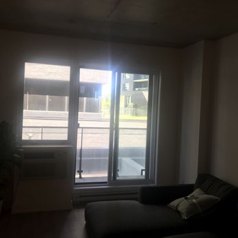 L'Hexagone Appartements - Living room and entrance to the balcony - Apartments Near Me - Montreal, Quebec L'Hexagone Appartements - Living room and entrance to the balcony - Apartments Near Me - Montreal, Quebec