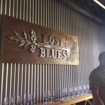Lost Blues - a man standing in front of a wall of wine glasses - Wine Tasting Room Near Me - Paso Robles, California Lost Blues - a man standing in front of a wall of wine glasses - Wine Tasting Room Near Me - Paso Robles, California