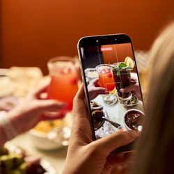 Everest Tandoori Kitchen - Guest taking photo of Indian food and drinks at Everest Tandoori Kitchen restaurant