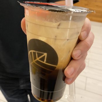 Pearl Fever Tea House - a person holding a cup of iced coffee - Coffee & Tea Near Me - Surrey, British Columbia Pearl Fever Tea House - a person holding a cup of iced coffee - Coffee & Tea Near Me - Surrey, British Columbia