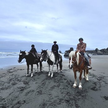 Bandon Beach Riding Stables - Three people on horses on the beach. - Horseback Riding Near Me - Bandon, Oregon