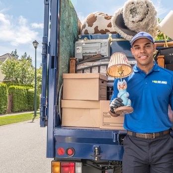 1-800-GOT-JUNK? Dallas Central - 1-800-GOT-JUNK? Truck Team Member with a loaded junk truck - Junk Removal & Hauling Near Me - Garland, Texas